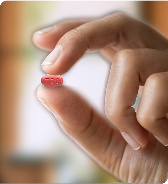 Image: Hand holding XPHOZAH tablet between two fingers 